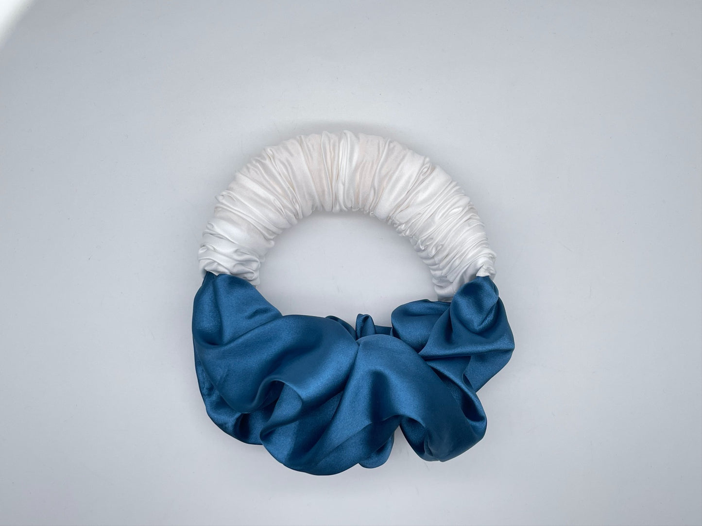 Luxe and Laurel white and blue sponge bun maker creating a voluminous French Twist 