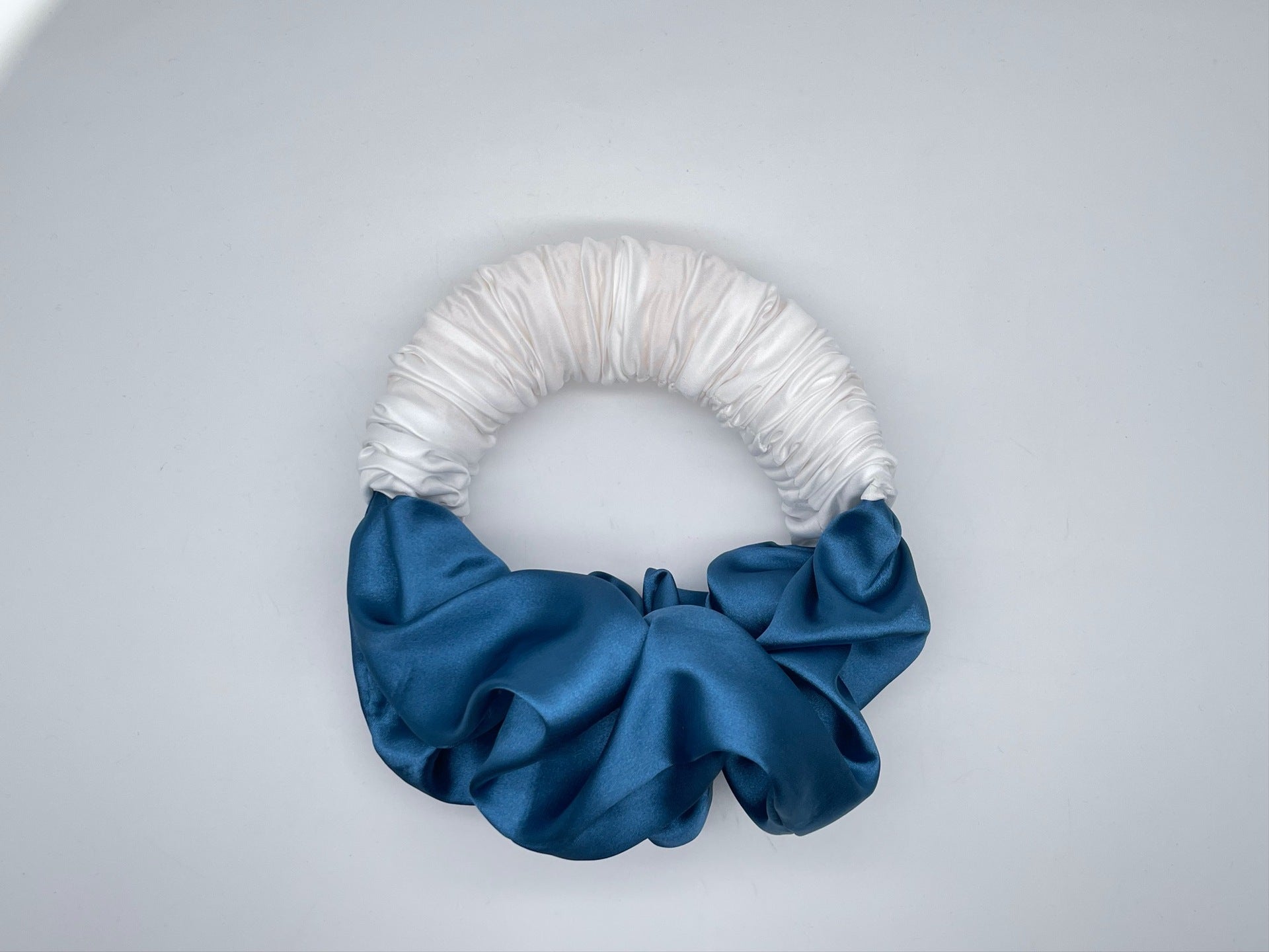 Luxe and Laurel white and blue sponge bun maker creating a voluminous French Twist 