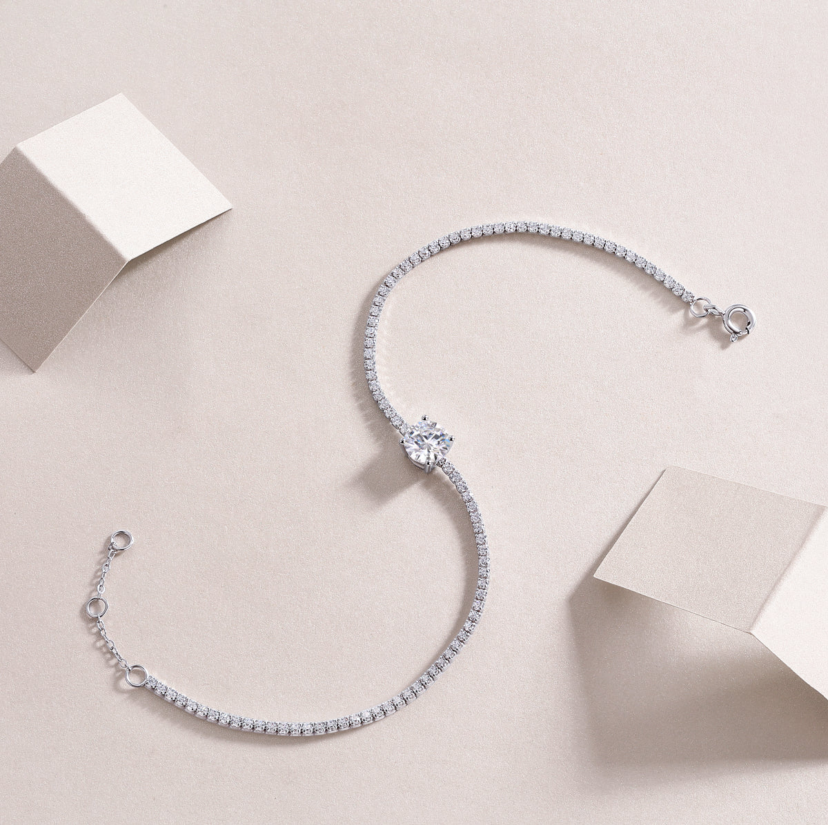 Silver bracelet with diamond accents on a light beige background