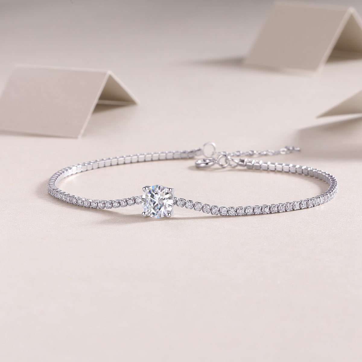 Silver bracelet with a diamond on a beige background