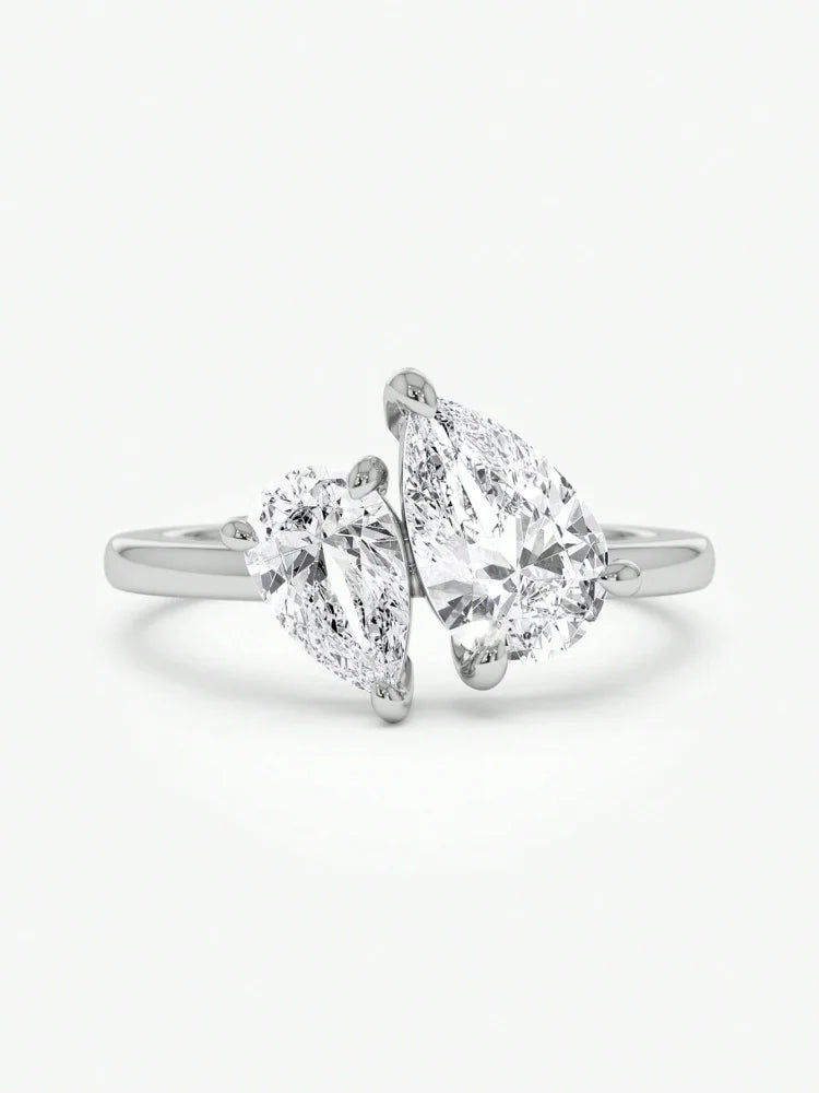 Diamond ring with pear-shaped stones on a white background