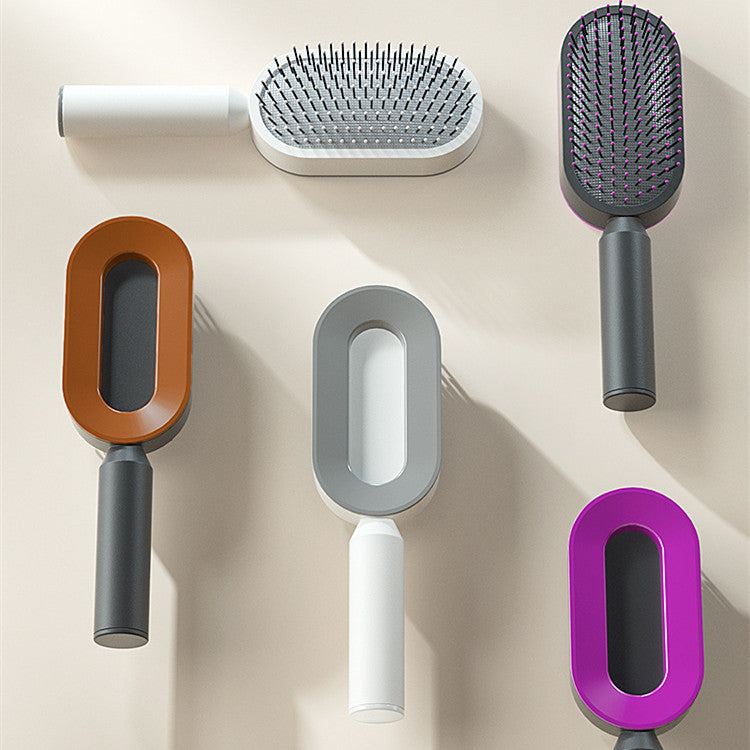 Demonstration of the one-click self-cleaning hair removal feature on the Luxe and Laurel white detangling scalp massage brush.