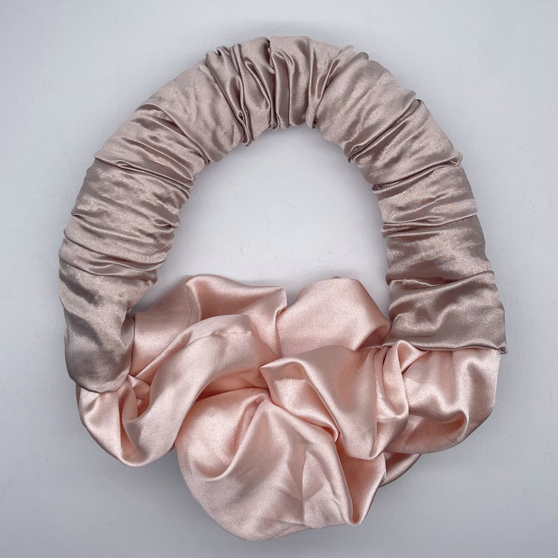 Pink satin hair scrunchie on a light gray background