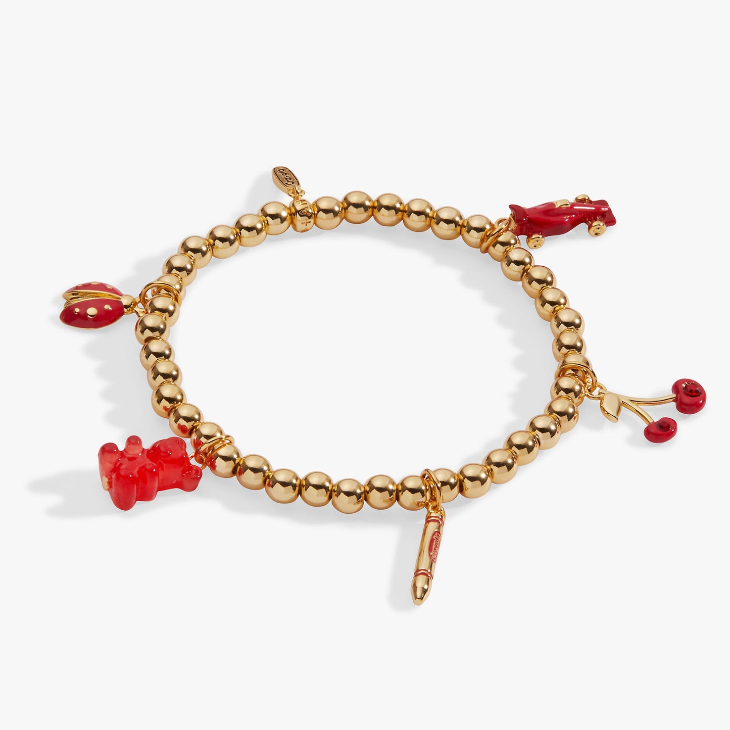 Gold bracelet with red charms on a white background