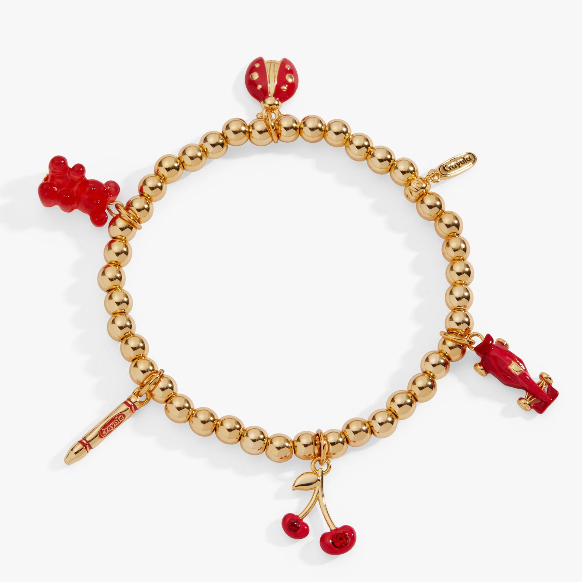 Gold beaded bracelet with red cherry charms on a white background