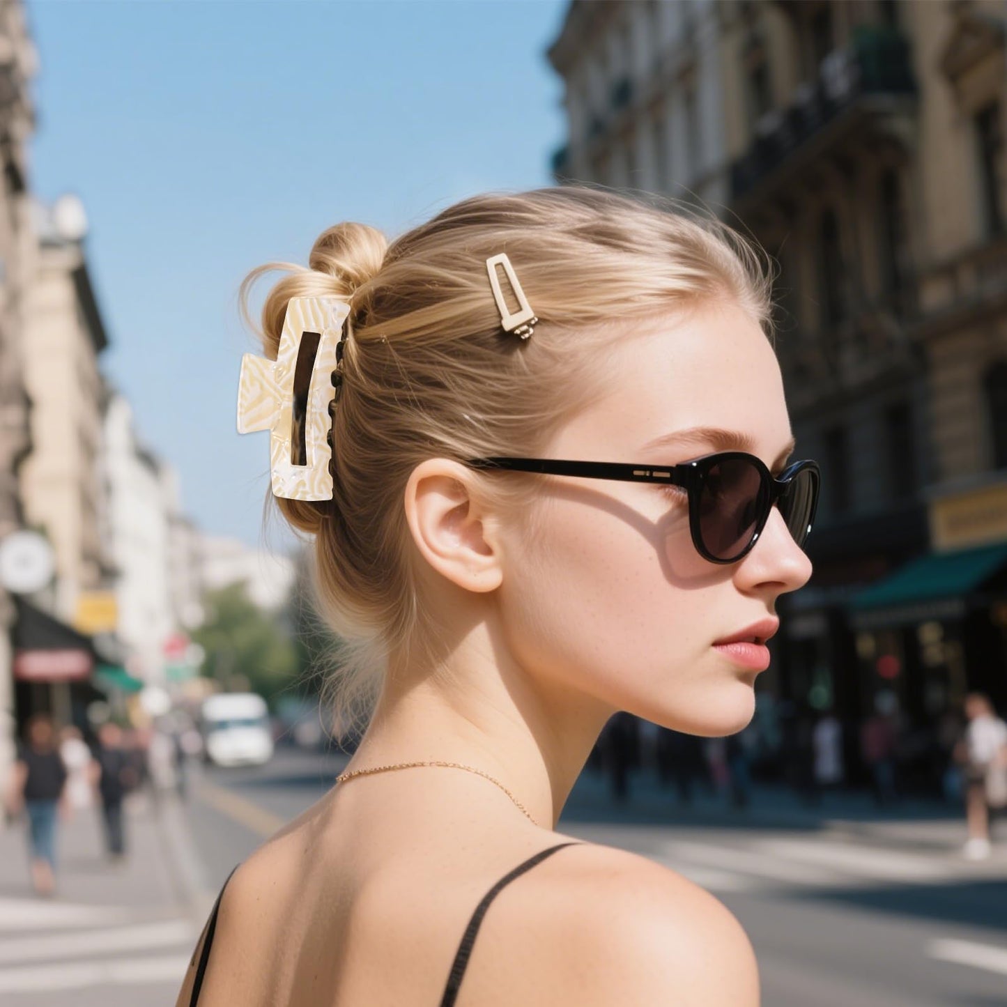 Woman with sunglasses and hair clips on a city street