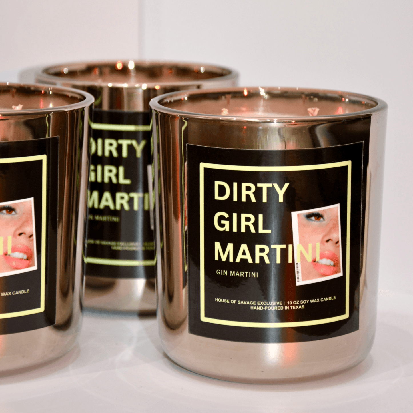Silver candles labeled 'Dirty Girl Martini' on a white background