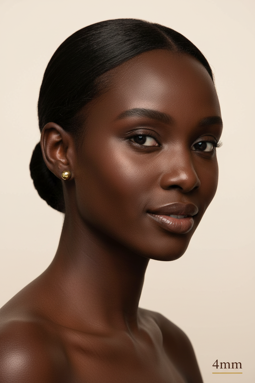 Woman with dark skin and hair styled in a bun against a beige background