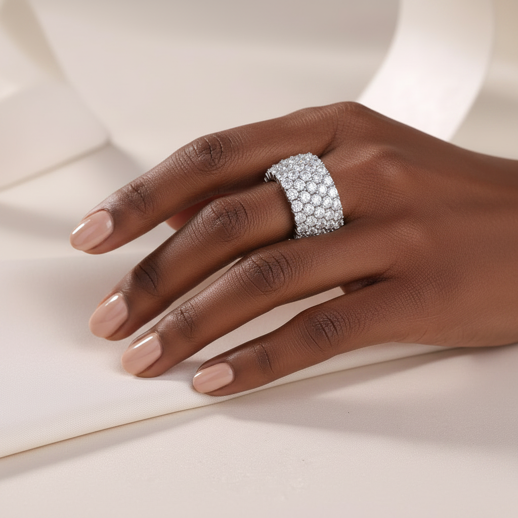 Pavé ring on dark-skinned model hand - quiet luxury